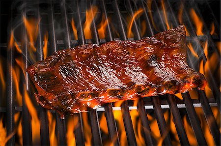 flame - Spare ribs on a barbecue Stock Photo - Premium Royalty-Free, Code: 659-08939906