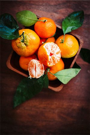 simsearch:659-06187804,k - Mandarins with leaves on a rustic wooden surface Stock Photo - Premium Royalty-Free, Code: 659-08940024