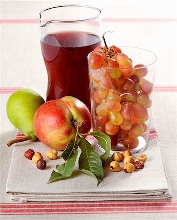 An arrangement of fresh fruit, hazelnuts and red wine Stock Photo - Premium Royalty-Free, Code: 659-08940364