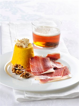 Truffled pumpkin flan with smoked ham and walnuts Stock Photo - Premium Royalty-Free, Code: 659-08940573
