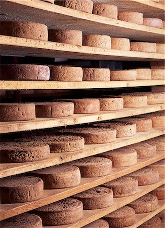 simsearch:659-03527833,k - Wheels of Toma piemontese cheese ripening on shelves Stock Photo - Premium Royalty-Free, Code: 659-08940607