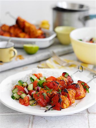 simsearch:659-08940641,k - Chicken kebabs with a cucumber and tomato salad Stock Photo - Premium Royalty-Free, Code: 659-08940626