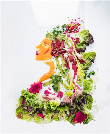 simsearch:659-06494461,k - A portrait of a woman made from lettuce, vegetables and fruit on a white surface Photographie de stock - Premium Libres de Droits, Code: 659-08940899