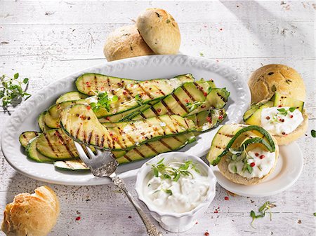 Marinated grilled courgettes with a sheep's cheese sauce and bread rolls Stock Photo - Premium Royalty-Free, Code: 659-08940921