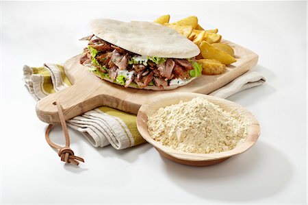 doner kebap kebab - A doner kebab on a chopping board Stock Photo - Premium Royalty-Free, Code: 659-09124184