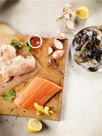 simsearch:659-09125442,k - An arrangement of chicken, salmon, seafood, garlic, lemon and spices Stock Photo - Premium Royalty-Free, Code: 659-09125186