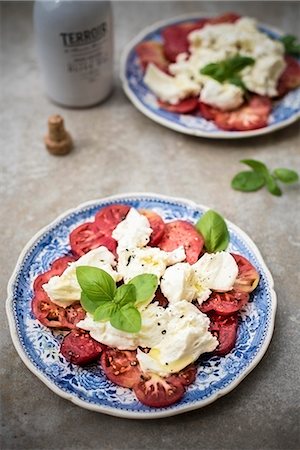 Caprese salad (tomato, mozzarella and basil) Stock Photo - Premium Royalty-Free, Code: 659-09125379