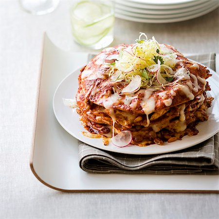 A stack of enchiladas with minced meat, beans and cheese (Mexico) Stock Photo - Premium Royalty-Free, Code: 659-09125616