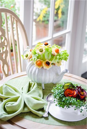 flower arrangement in a teacup - Bouquet of salad leaves and flowers made with cheese, carrots and avocado in a teapot, watercress and carrots in a tea cup on a green tablemat Stock Photo - Premium Royalty-Free, Code: 659-09125824
