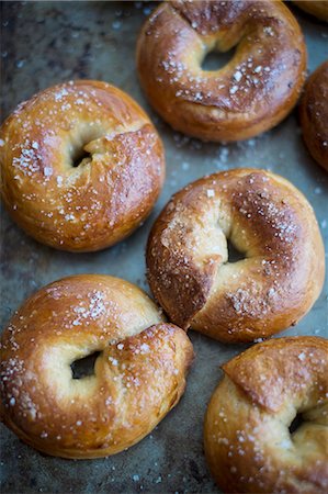 Crisp bagels with sea salt on a baking tray Stock Photo - Premium Royalty-Free, Code: 659-09125865