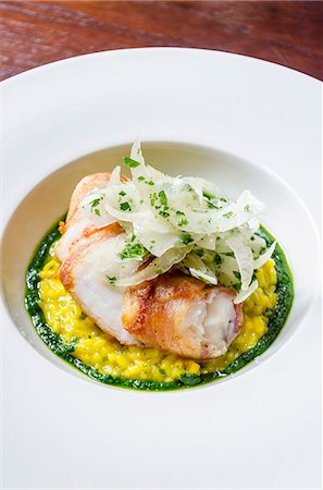 simsearch:659-08895741,k - Sea bass fish fillet fricasee on a saffron risotto with wild fennel, basil, chilli Stock Photo - Premium Royalty-Free, Code: 659-09125890