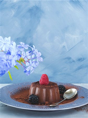 simsearch:659-06154772,k - Chocolate panna cotta dessert garnished with berries over blue gray background Stock Photo - Premium Royalty-Free, Code: 659-09125942