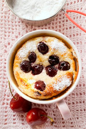 Quark and semolina pudding with cherries and icing sugar in cup Stock Photo - Premium Royalty-Free, Code: 659-01844233