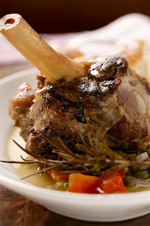 Braised lamb shank with vegetables & rosemary on plate Stock Photo - Premium Royalty-Free, Code: 659-01844264