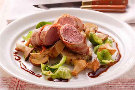 Venison fillet in bacon, forest mushrooms & Brussels sprouts Stock Photo - Premium Royalty-Free, Code: 659-01844610