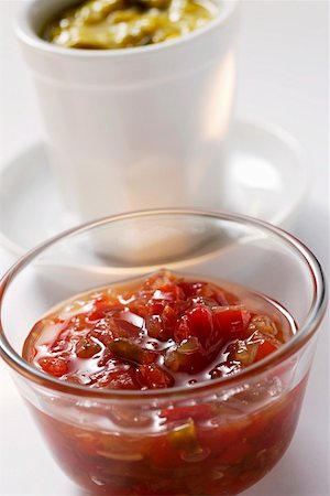 Pepper relish in small bowl, mustard relish behind it Stock Photo - Premium Royalty-Free, Code: 659-01844684