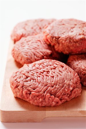 simsearch:659-01846050,k - Raw burgers on wooden chopping board Stock Photo - Premium Royalty-Free, Code: 659-01844686