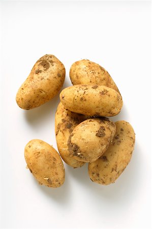 Several potatoes with soil Foto de stock - Sin royalties Premium, Código: 659-01844761