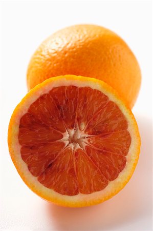 A whole and a half of a blood orange Stock Photo - Premium Royalty-Free, Code: 659-01844785