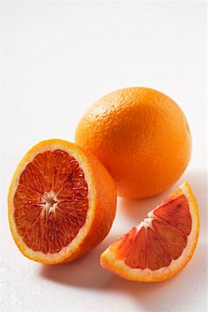 Blood oranges (whole, halved and wedge) Stock Photo - Premium Royalty-Free, Code: 659-01844787