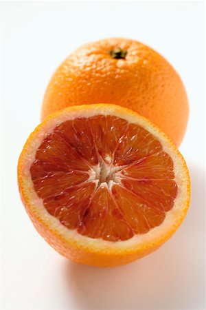 A whole and a half of a blood orange Stock Photo - Premium Royalty-Free, Code: 659-01844798