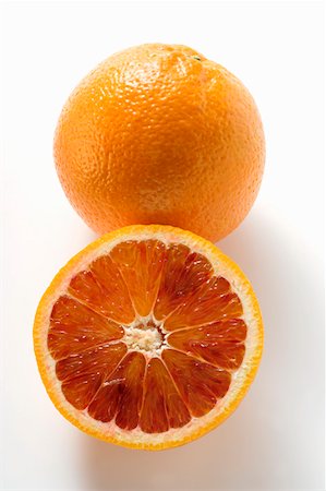A whole and a half of a blood orange Stock Photo - Premium Royalty-Free, Code: 659-01844802