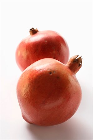 simsearch:659-03523579,k - Two whole fresh pomegranates Stock Photo - Premium Royalty-Free, Code: 659-01844815