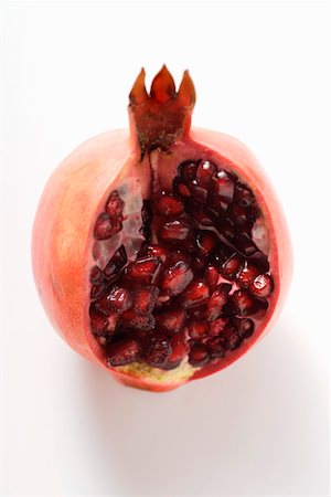 pomegranate cut up - Pomegranate, a piece cut off Foto de stock - Sin royalties Premium, Código: 659-01844822