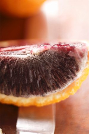 Wedge of blood orange on knife Stock Photo - Premium Royalty-Free, Code: 659-01844982
