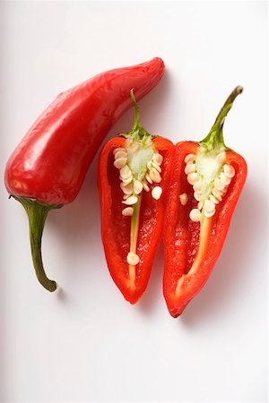 peperoncino - Two red chili peppers, one halved Stock Photo - Premium Royalty-Free, Code: 659-01845054