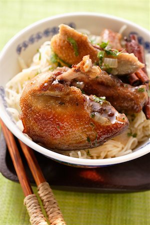 squab - Roast pigeon on noodles in Asian bowl, chopsticks Stock Photo - Premium Royalty-Free, Code: 659-01845437