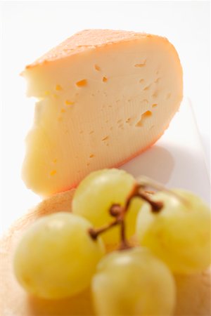 Piece of Chaumes cheese with green grapes Stock Photo - Premium Royalty-Free, Code: 659-01845430