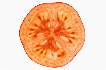 Slice of tomato, backlit Stock Photo - Premium Royalty-Free, Code: 659-01845525