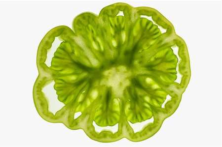 Slice of green tomato (cross- section), backlit Stock Photo - Premium Royalty-Free, Code: 659-01845551