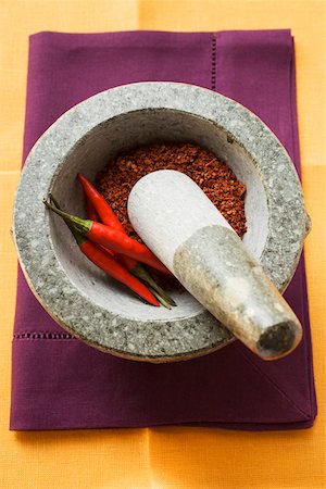 Chili peppers and chili powder in mortar Stock Photo - Premium Royalty-Free, Code: 659-01845678