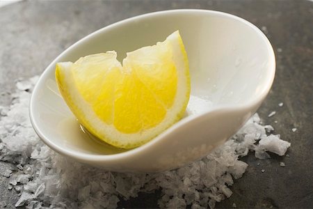 simsearch:659-03524247,k - Lemon wedge with olive oil in a small bowl on salt Stock Photo - Premium Royalty-Free, Code: 659-01845694