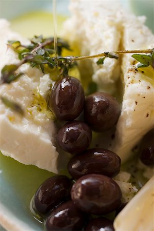 Feta cheese with olives, olive oil and thyme Stock Photo - Premium Royalty-Free, Code: 659-01845716