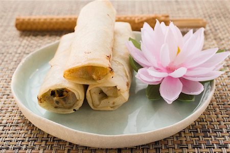 spring roll - Three spring rolls and water lily Stock Photo - Premium Royalty-Free, Code: 659-01845758