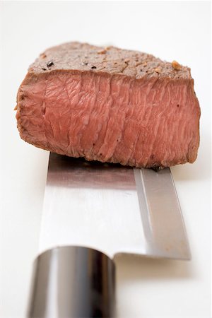steak knife - Beef steak, a piece cut off, on Asian knife Stock Photo - Premium Royalty-Free, Code: 659-01845770