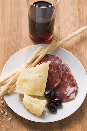 Salami, cheese, olives and grissini on plate Stock Photo - Premium Royalty-Free, Code: 659-01845857