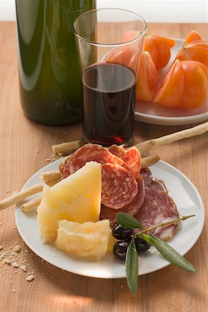 simsearch:659-01867530,k - Salami, cheese, olives & grissini on plate, tomatoes, wine Stock Photo - Premium Royalty-Free, Code: 659-01845858