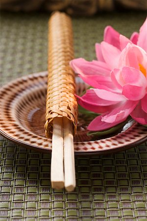 simsearch:659-01846629,k - Chopsticks in woven wrapper with water lily on plate Stock Photo - Premium Royalty-Free, Code: 659-01845962