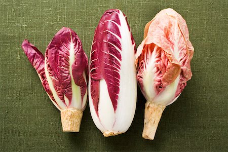 Three different types of radicchio on green background Fotografie stock - Premium Royalty-Free, Codice: 659-01846008