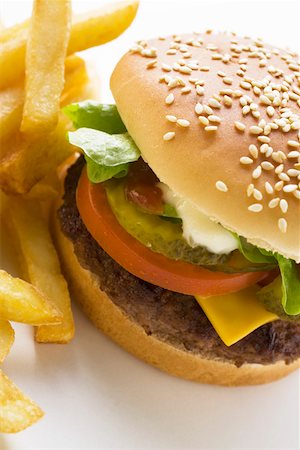 simsearch:659-01846088,k - Cheeseburger and Fries on a Plate Foto de stock - Sin royalties Premium, Código: 659-01846078