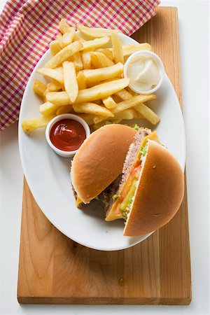 simsearch:659-01847504,k - Cheeseburger, chips, mayonnaise, ketchup on plate Stock Photo - Premium Royalty-Free, Code: 659-01846111