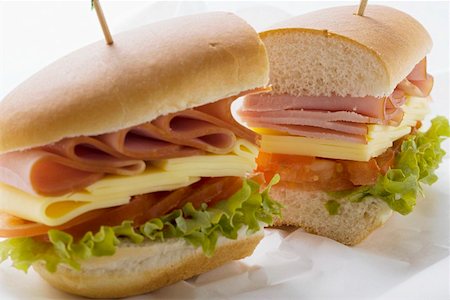 simsearch:659-03533100,k - Sub sandwich, halved, on sandwich wrap Foto de stock - Sin royalties Premium, Código: 659-01846140