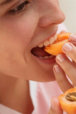 eaten - Woman biting into apricot Stock Photo - Premium Royalty-Free, Code: 659-01846185