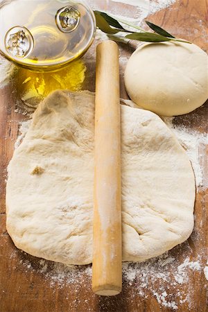 raw pizza - Rolled out & ball of dough, rolling pin, olive oil & branch Stock Photo - Premium Royalty-Free, Code: 659-01846368