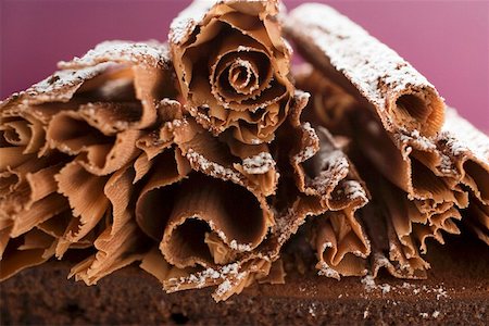 sugar decoration - Chocolate curls with icing sugar on chocolate cake Stock Photo - Premium Royalty-Free, Code: 659-01846414