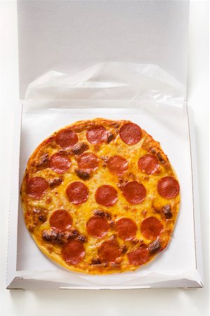 fast food delivery dish - Whole salami and cheese pizza in pizza box Stock Photo - Premium Royalty-Free, Code: 659-01846461